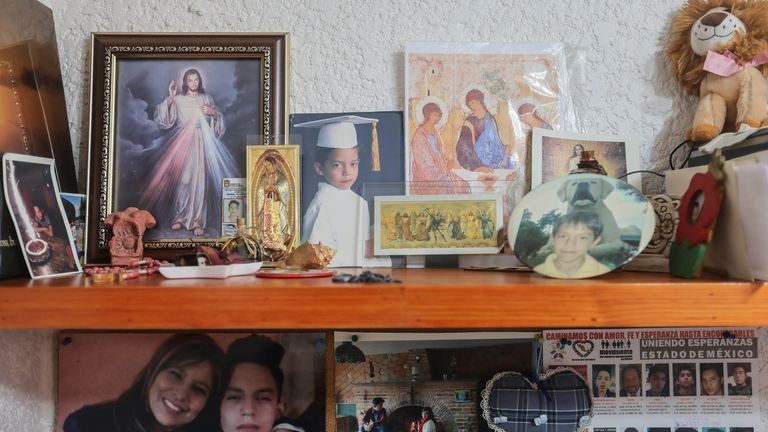 Childhood photos of Diego Maximiliano stand with religious images in...