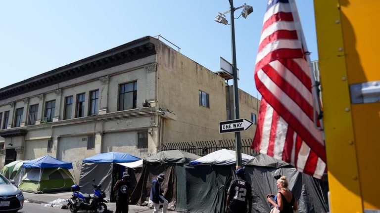 Tents are setup on a sidewalk, Thursday, July 25, 2024,...