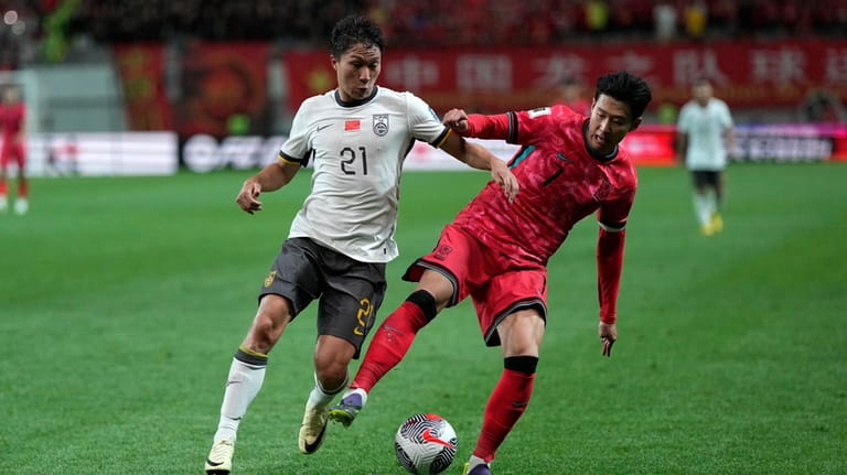South Korea's Son Heung-min, right, fights for the ball against...