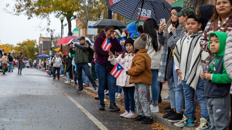 Paradegoers brave the rain on Main street during Patchogue Village's...