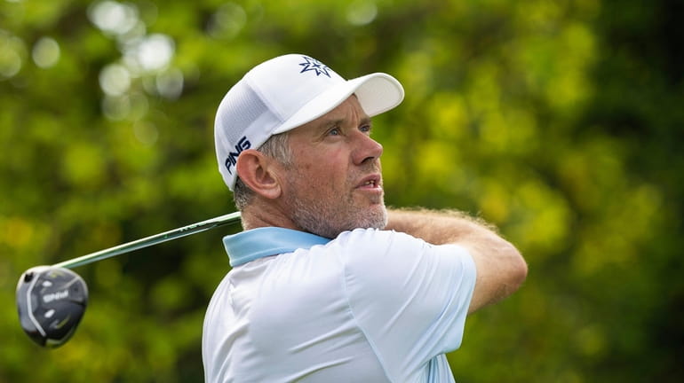 Lee Westwood hits his shot from the 16th tee during...