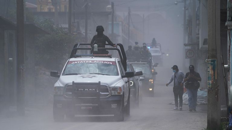 Police patrol the streets as ash from the Popocatepetl volcano...