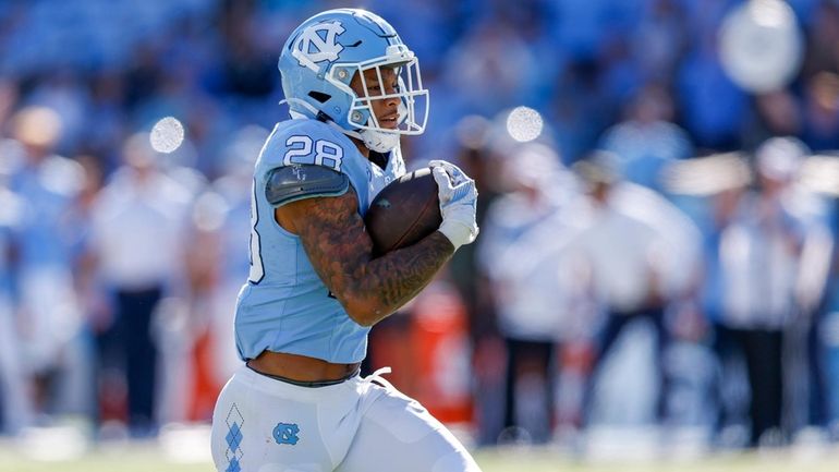 North Carolina running back Omarion Hampton runs for a touchdown...