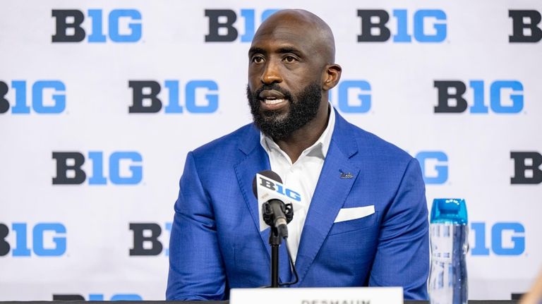 UCLA head coach DeShaun Foster talks with reporters during an...