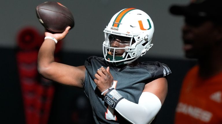 Miami quarterback Cam Ward aims a pass during NCAA college...