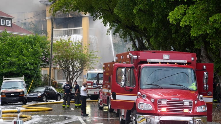 City of Miami Fire Rescue firefighters work at the scene...