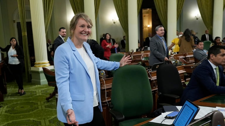 Assemblywoman Buffy Wicks, D-Oakland, smiles after measure that would force...