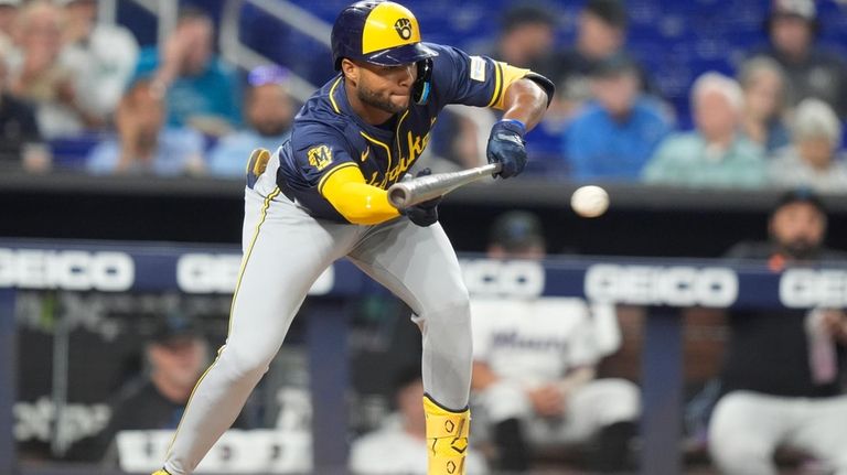 Milwaukee Brewers' Jackson Chourio bunts before being called out at...