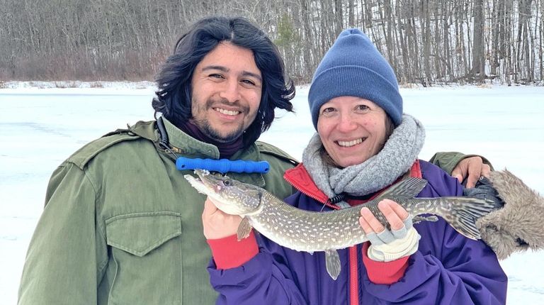 A pair of anglers shows off a catch made while...