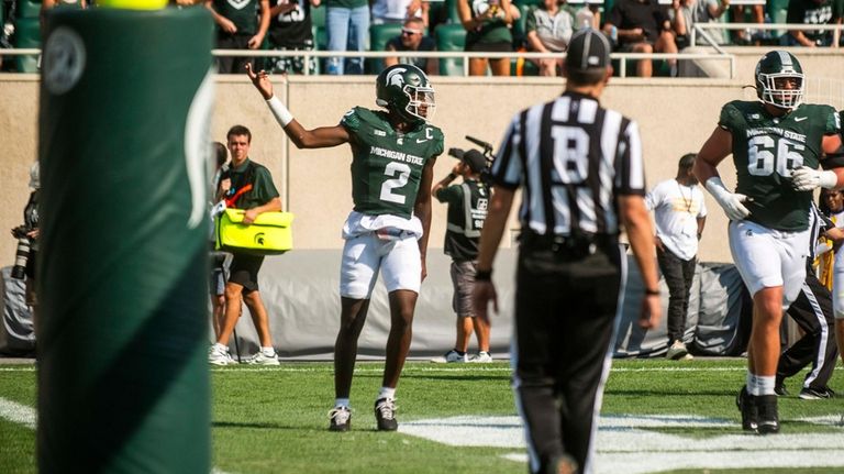 Michigan State quarterback Aidan Chiles celebrates after scoring a touchdown...