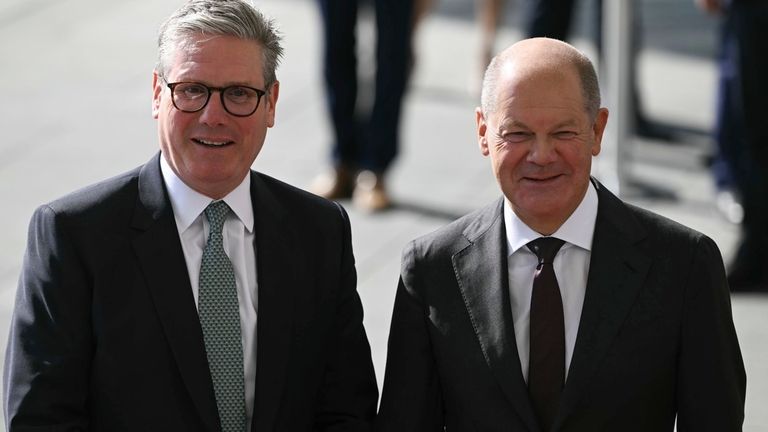 German Chancellor Olaf Scholz, right, greets Britain's Prime Minister Keir...