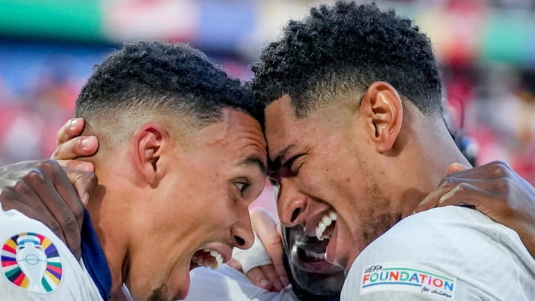 England's Jude Bellingham, right, and England's Trent Alexander-Arnold celebrate after...