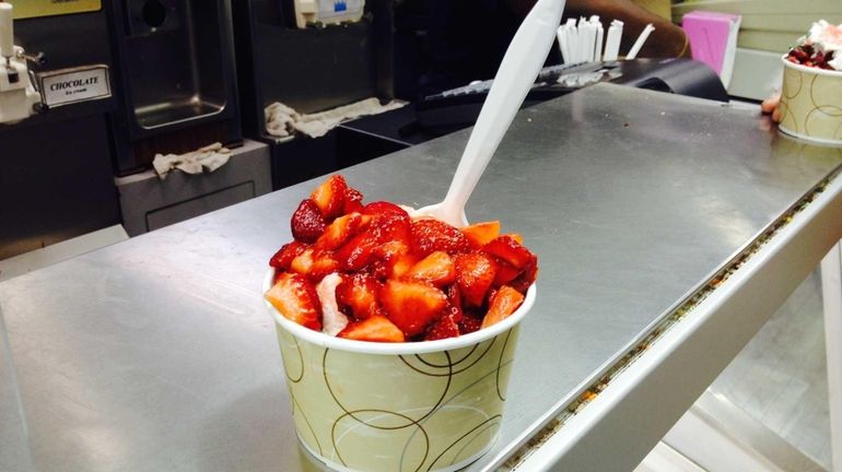 Fresh local strawberries top a sundae at Snowflake in Riverhead,...