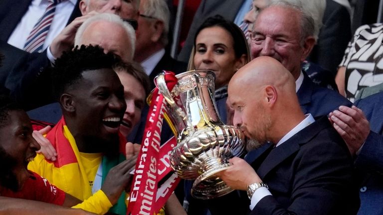 Manchester United's head coach Erik ten Hag, right, kisses the...