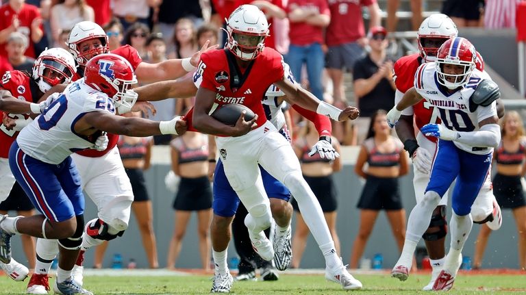 North Carolina State quarterback CJ Bailey (16) runs the ball...