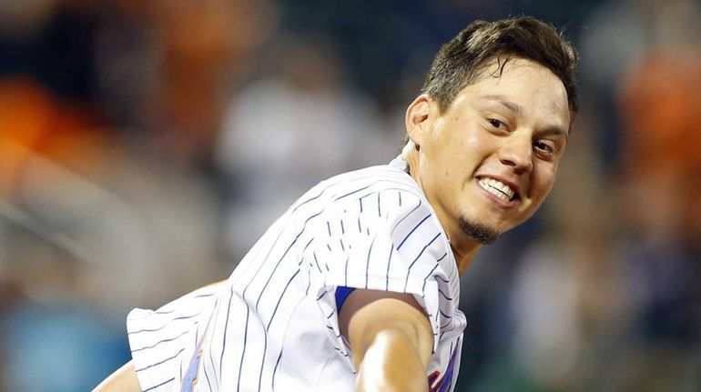 Wilmer Flores #4 of the New York Mets celebrates his...