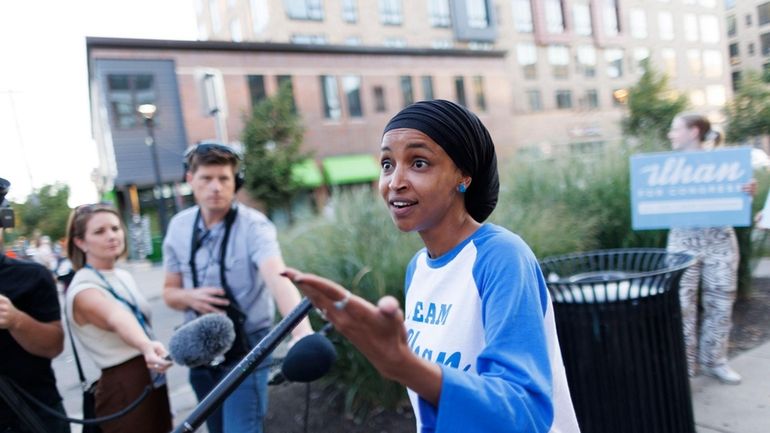 Rep. Ilhan Omar talks with media during a campaign stop...