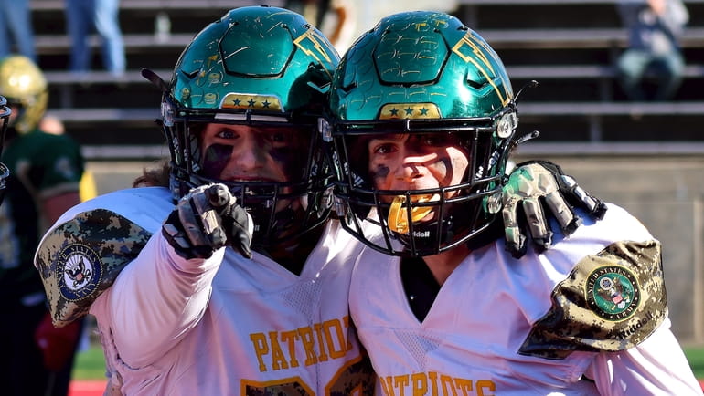 Ward Melville QB Andrew Belli celebrates his touchdown with OL...