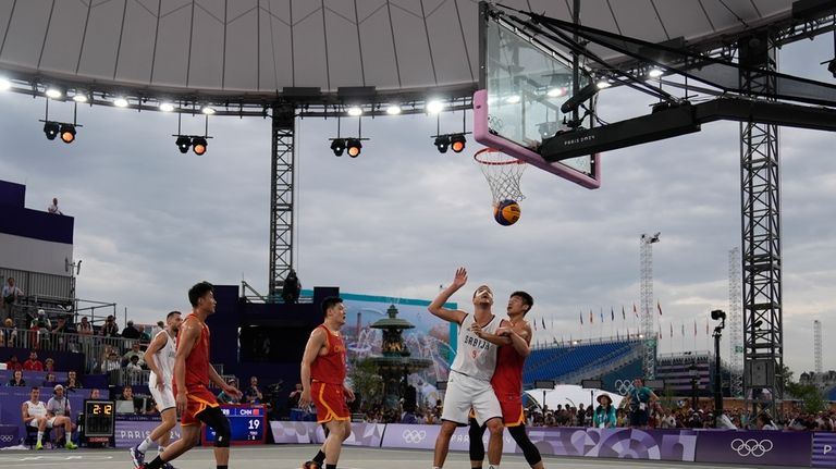 China's Lu Wenbo, right, and Serbia's Mihailo Vasic battle under...