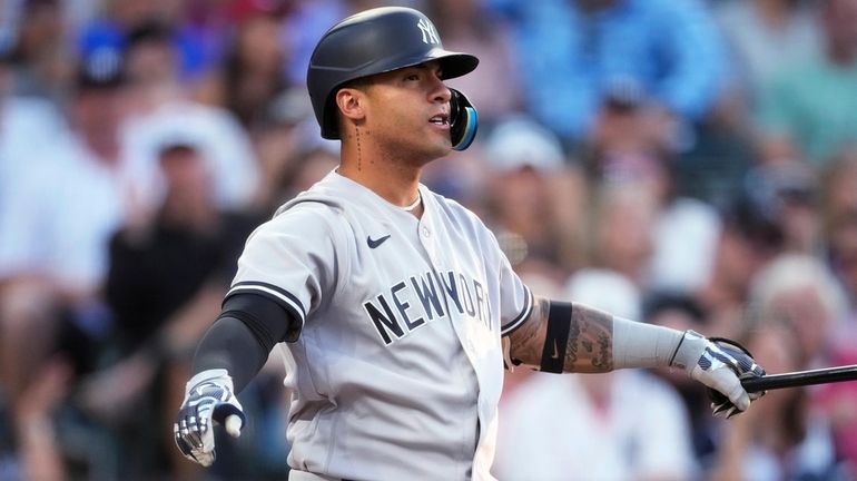 The Yankees' Gleyber Torres reacts after striking out against Rockies...