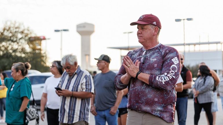 Uvalde mayoral candidate Cody Smith gestures toward a voter waiting...