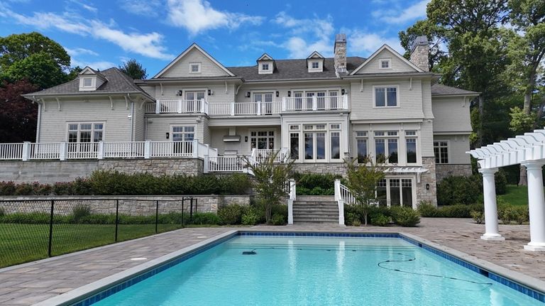 The Upper Brookville estate includes a pool and a pool...