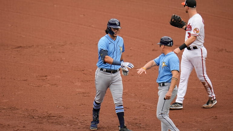 Tampa Bay Rays' Tristan Gray, left, reacts with first base...