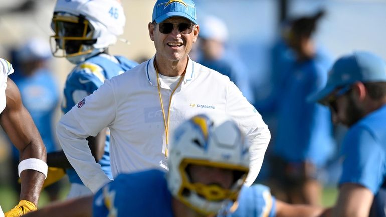 Los Angeles Chargers head coach Jim Harbaugh watches practice during...