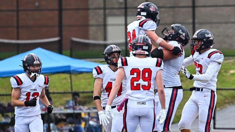 The South Side offense celebrates a touchdown by Jack Lozito during...