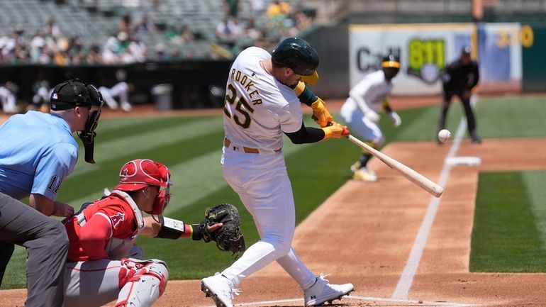 Oakland Athletics' Brent Rooker (25) hits a three-run home run...