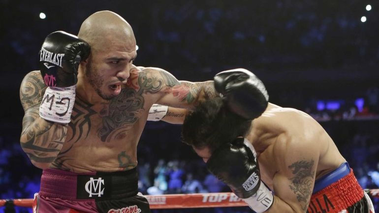 Miguel Cotto, left, of Puerto Rico, fights Sergio Martinez, of...