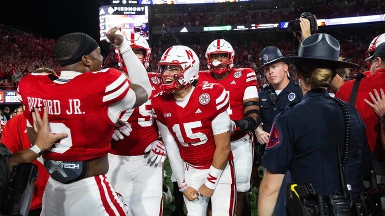 Nebraska quarterback Dylan Raiola (15) celebrates with defensive back Marques...