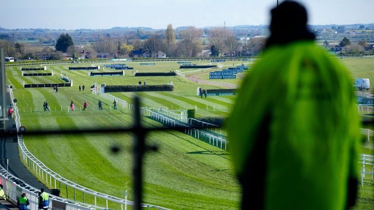 Racegoers arrive at Aintree Racecourse before the Grand National horse...