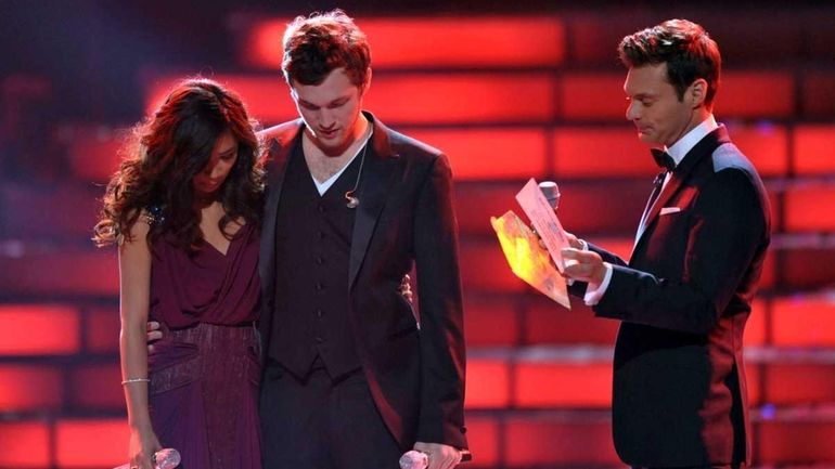 Finalists Jessica Sanchez, left, and Phillip Phillips, center, listen as...