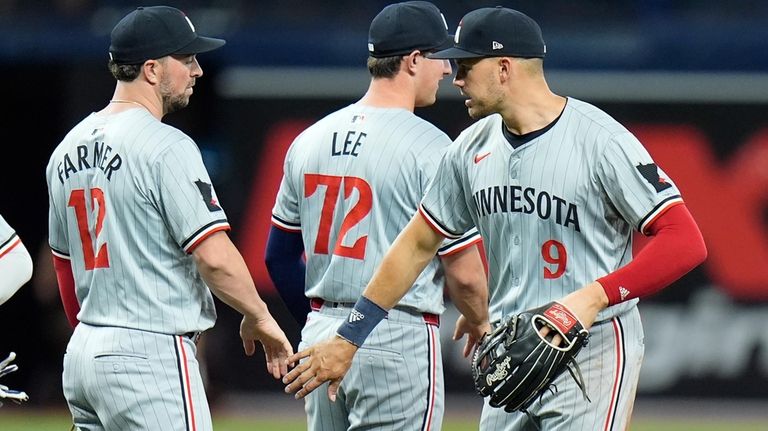 Minnesota Twins' Trevor Larnach (9) celebrates with Brooks Lee (72)...