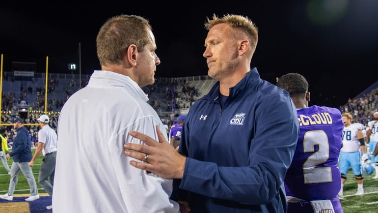 James Madison coach Curt Cignetti, left, meets with Old Dominion...