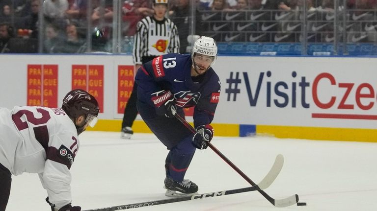 Unted States' Johnny Gaudreau, right, challenges for a puck with...