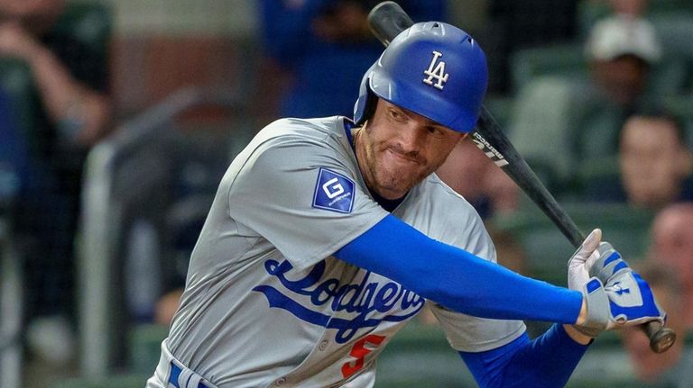 Los Angeles Dodgers' Freddie Freeman swings in the fourth inning...