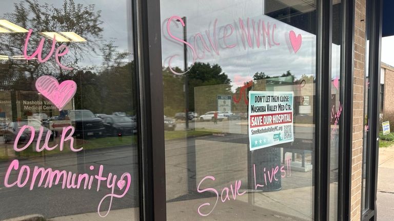 Heartfelt notes are written on windows outside of the Nashoba...