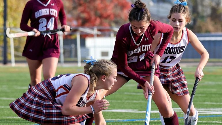 Garden City midfield Catalina Suau stick handles past two Iroquois...