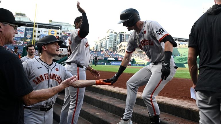 San Francisco Giants' Tyler Fitzgerald, right, celebrates his home run...