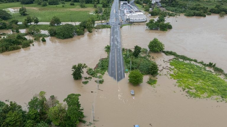 La Plata river floods a road after Tropical Storm Ernesto...