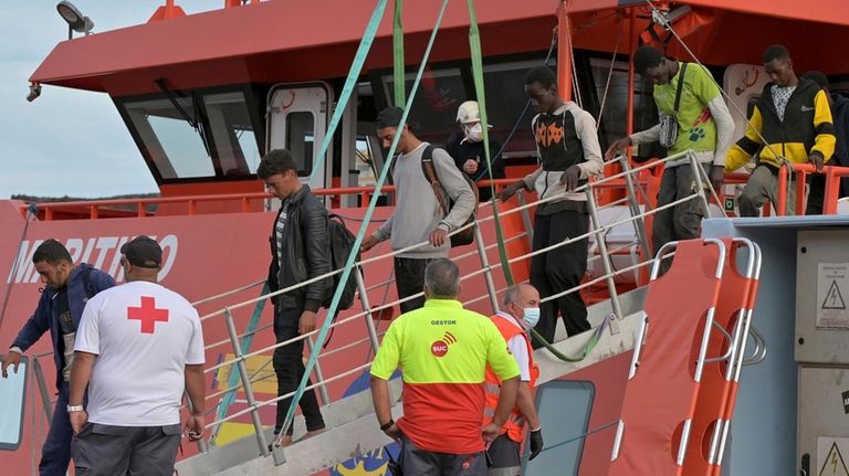 Young migrants arrive in the port of La Restinga at...