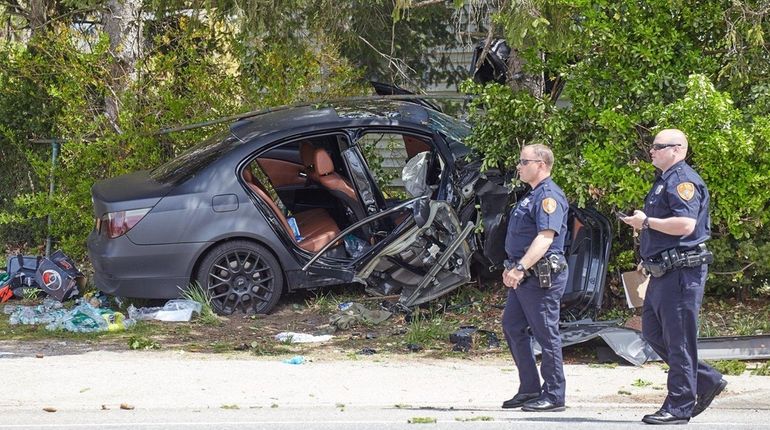 Suffolk County police investigate a car crash Thursday morning, April...