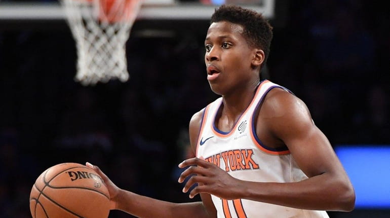 Knicks guard Frank Ntilikina brings the ball up court against...
