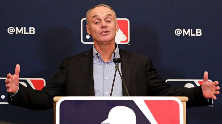 Commissioner Rob Manfred answers questions at a press conference during...