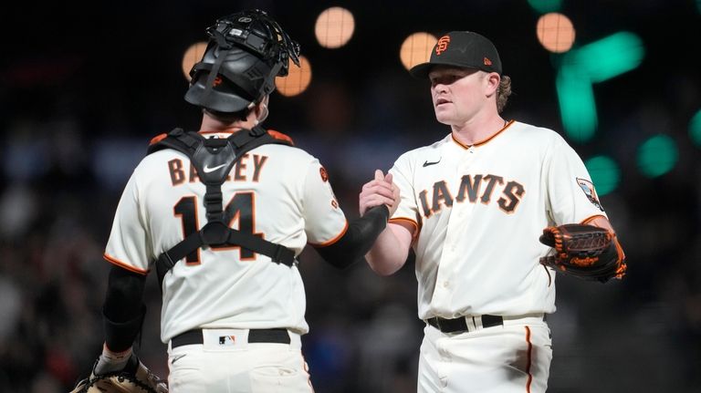 San Francisco Giants catcher Patrick Bailey, left, celebrates with pitcher...