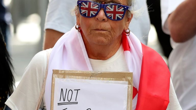 A protester shows a placard during a far-right anti-immigration protest...