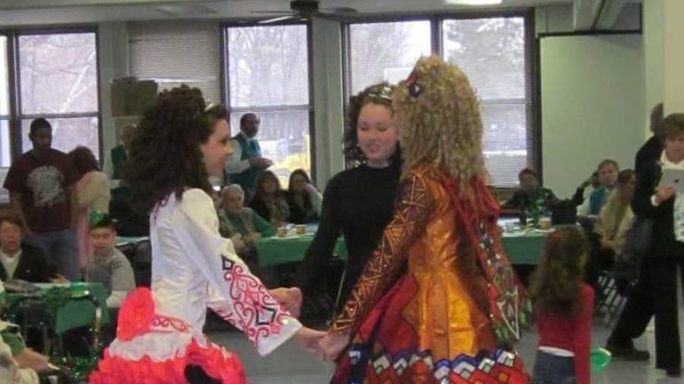Irish dancers held hands while forming a circle as they...