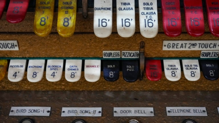 Some of the organ stops on the console of the...